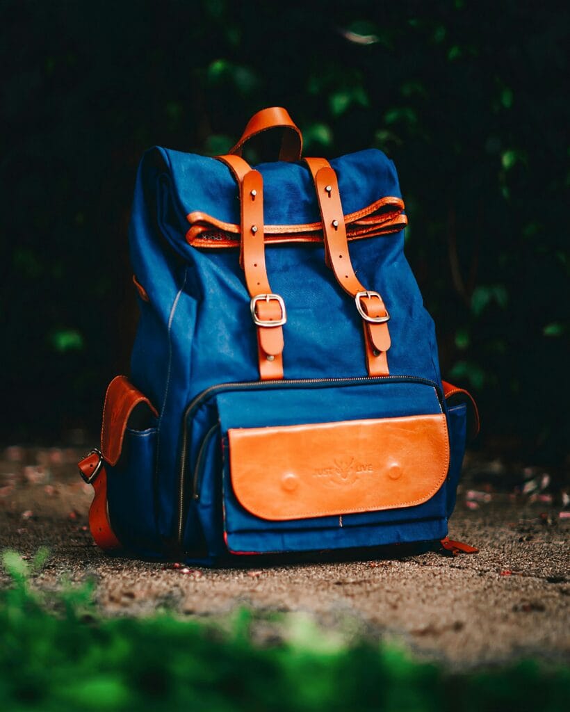 Elegant blue backpack with brown leather accents, ideal for travel and adventure.