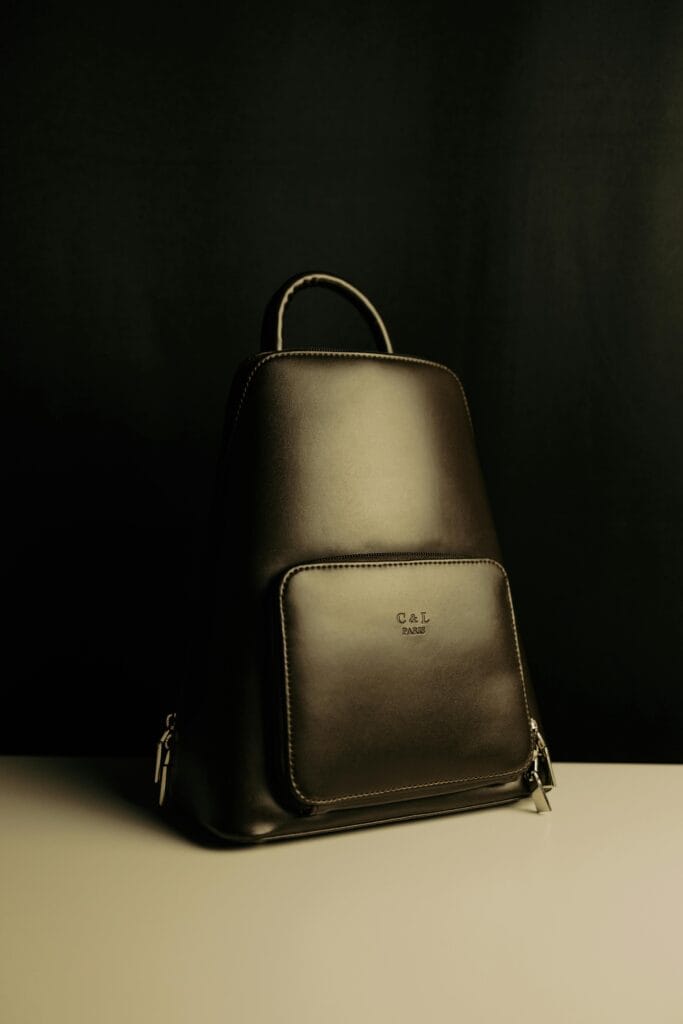 Sleek leather backpack displayed against a moody background with premium craftsmanship.